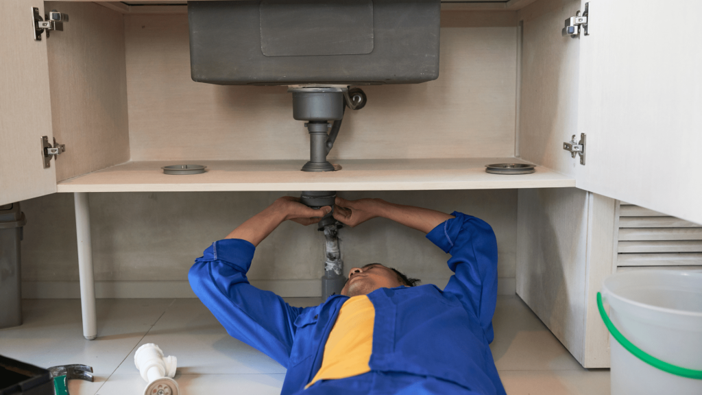 A close-up of a pipe joint with water seeping out, illustrating a typical point of failure for plumbing.