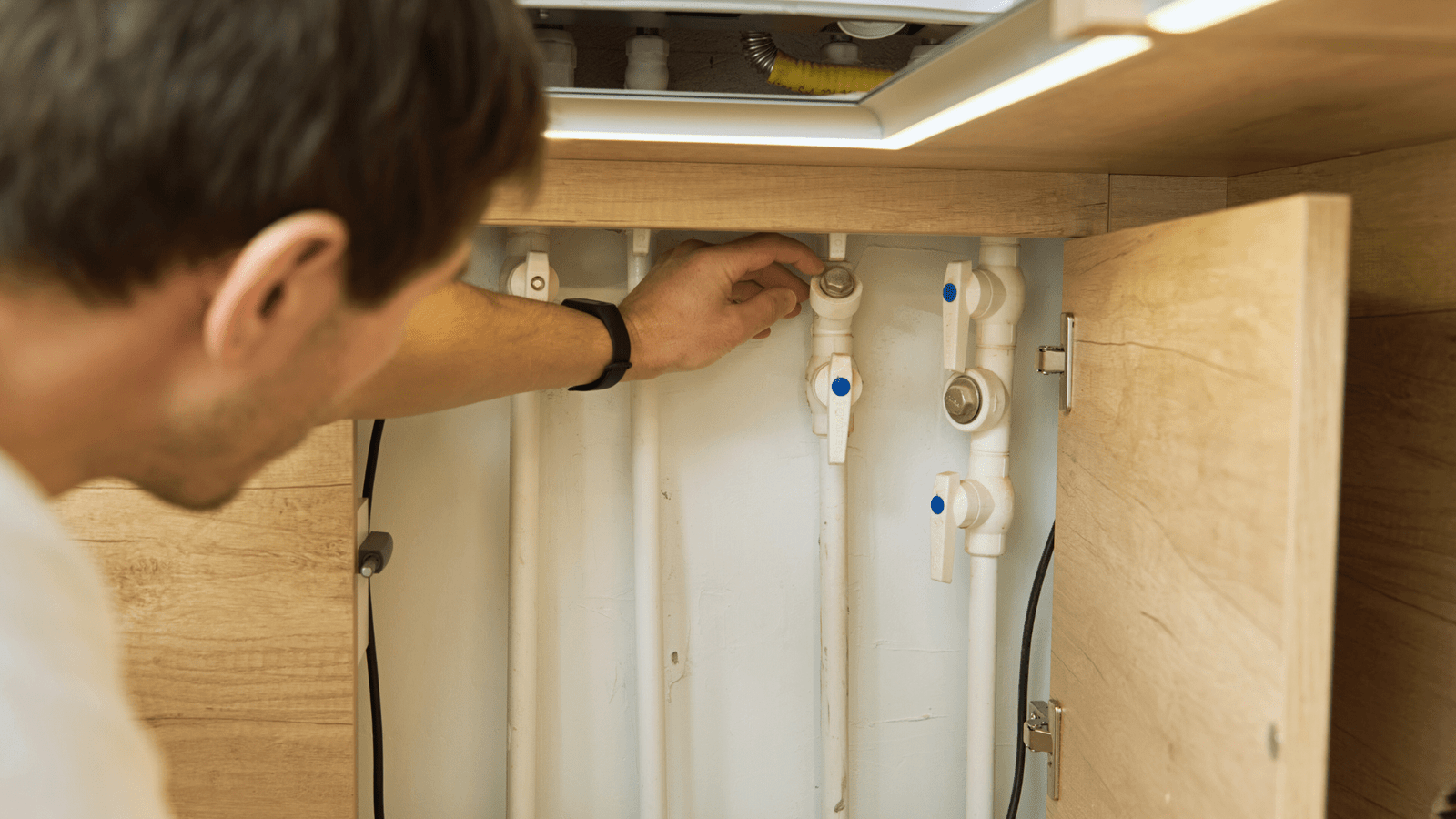 A Tubero Experts professional performing routine maintenance on a plumbing system, preventing future problems.

