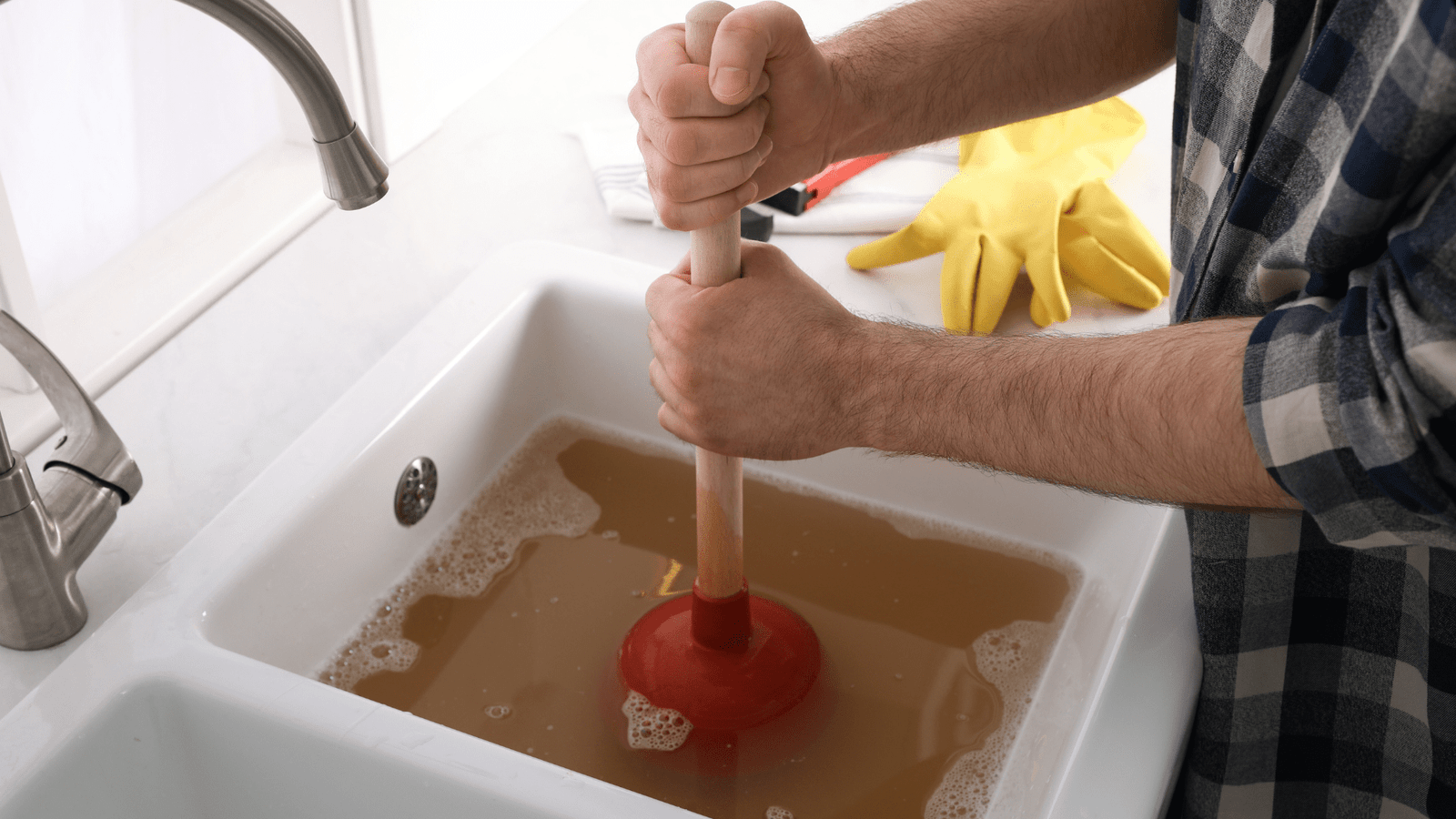 A kitchen sink completely backed up with food particles and standing water, illustrating a common and frustrating clog for a client.


