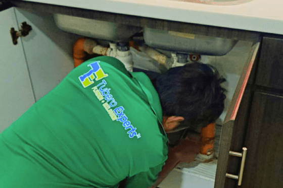"Plumbing team repairing kitchen sink in Cavite home"