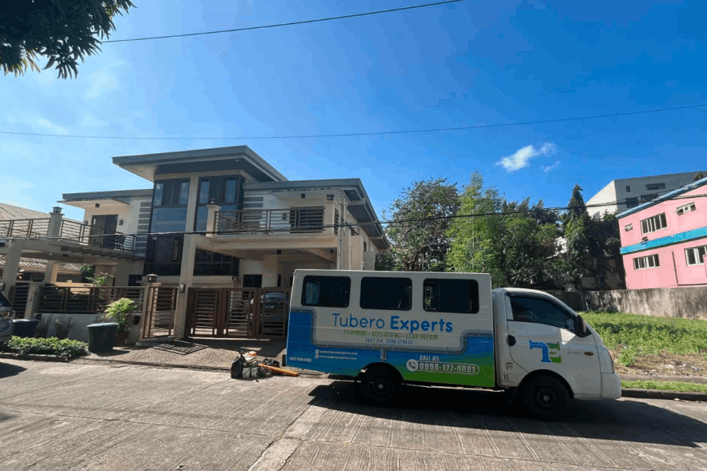 Tubero Experts plumbing and declogging service van parked at a residential project in Muntinlupa.