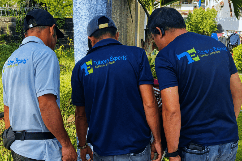 Plumber inspecting pipes during an on-site visit