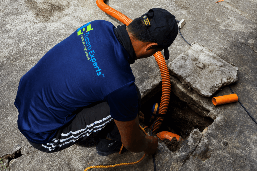 Tubero Experts technician inspecting a line as part of Repiping of Sanitary Line service