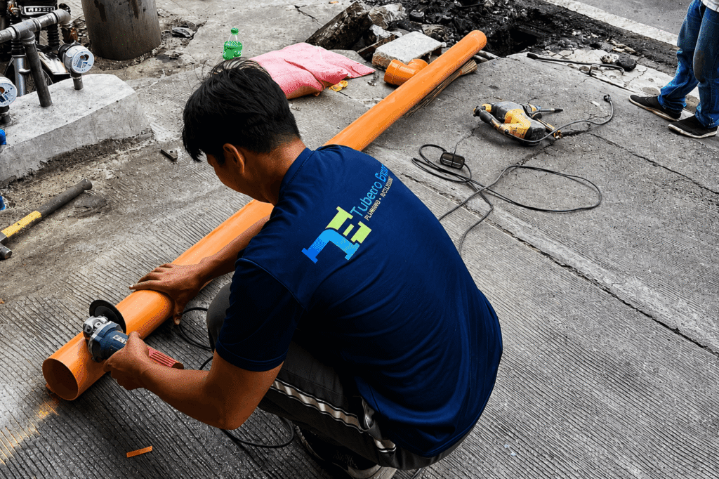 Tubero Experts plumber cutting PVC pipe for Repiping of Sanitary Line