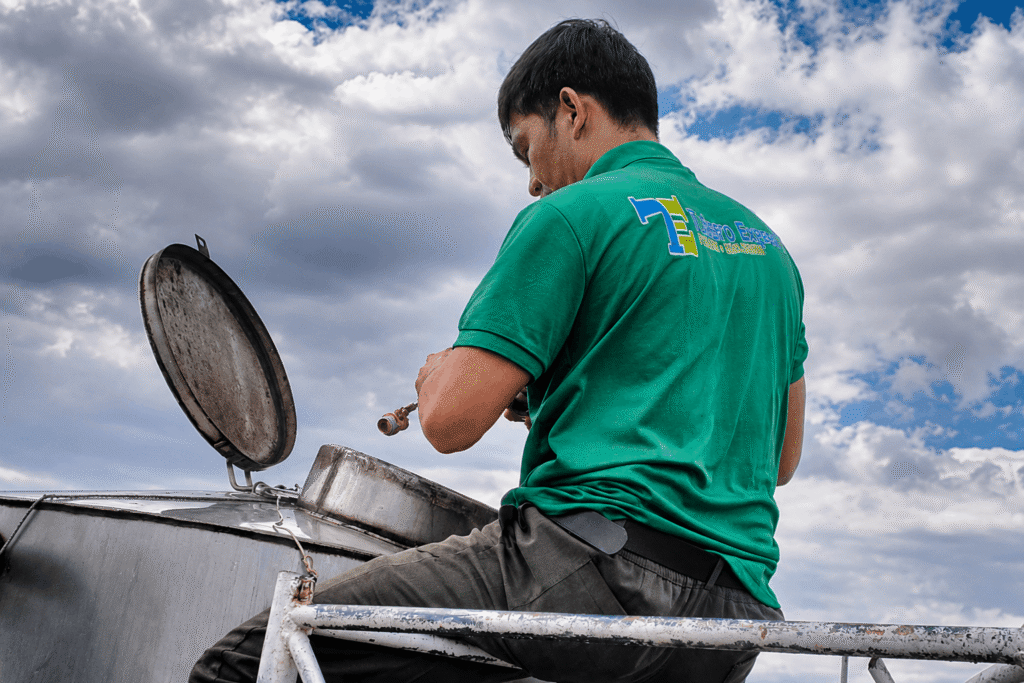 Tubero Experts technician working on a rooftop water tank fitting during pump installation