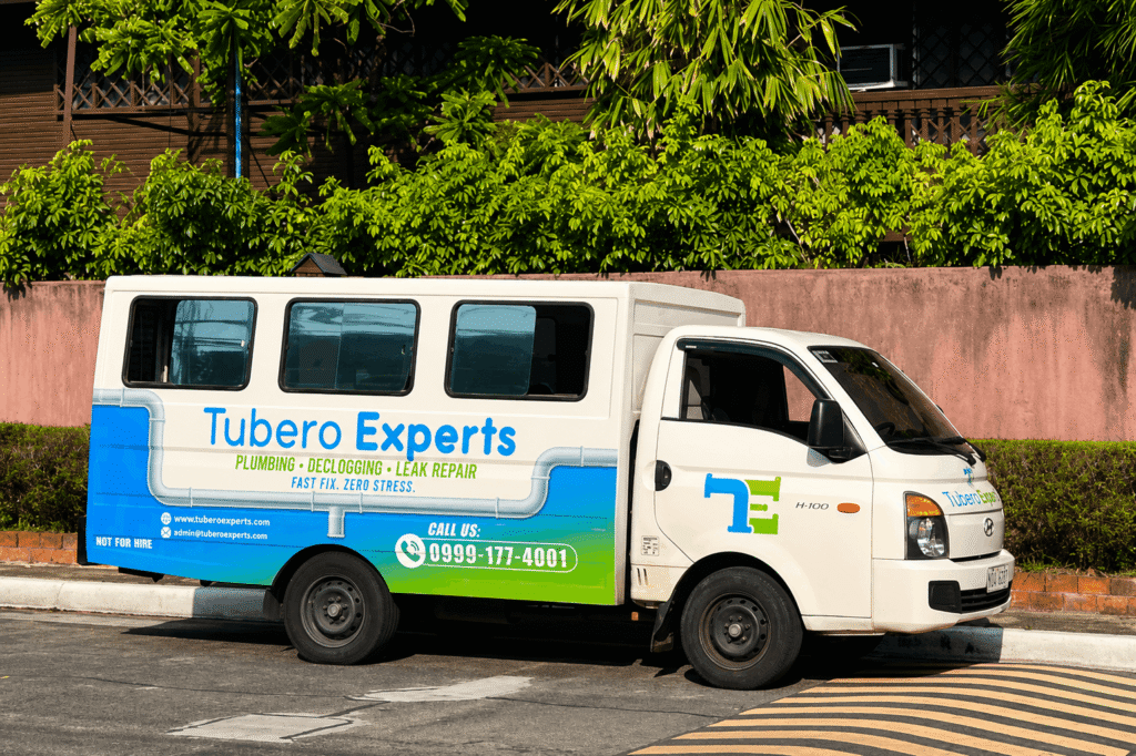 Tubero Experts service van parked on-site, ready for a plumbing and water pump installation job