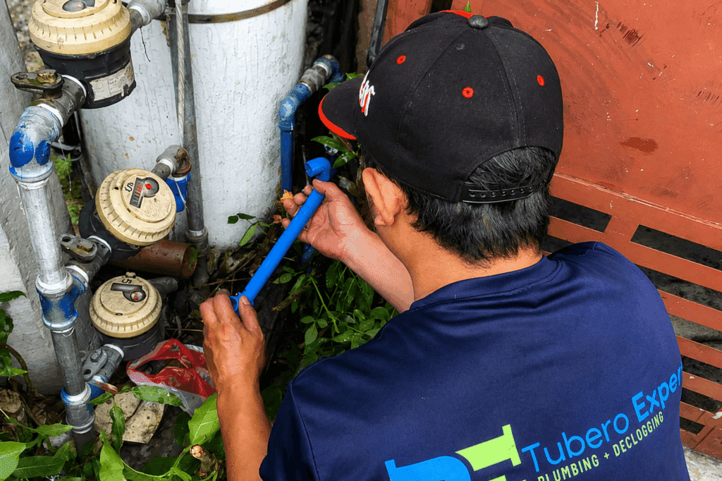 Tubero Experts technician performing water leak repair near water meter