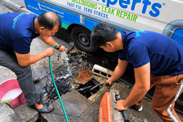 Thick buildup in a curbside drain needs more than a quick rinse. We break it loose, flush it through, and leave the line clear and draining.