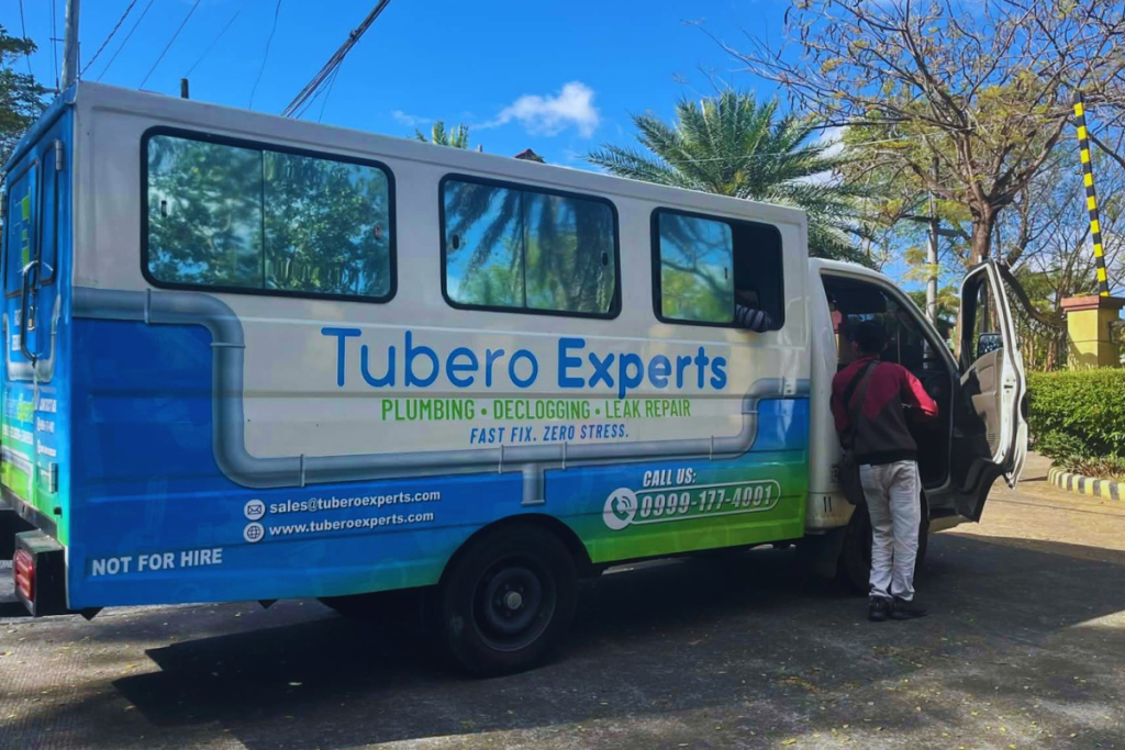 Tubero Experts service van parked on a tree-lined street