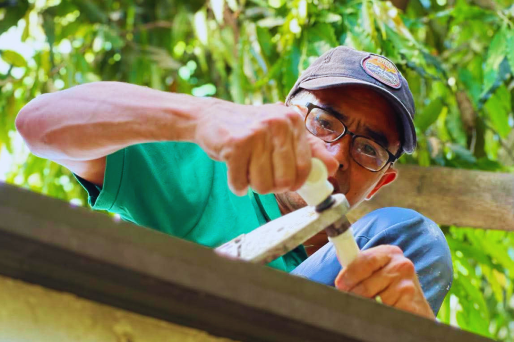 Plumber tightening a pipe fitting during a repair
