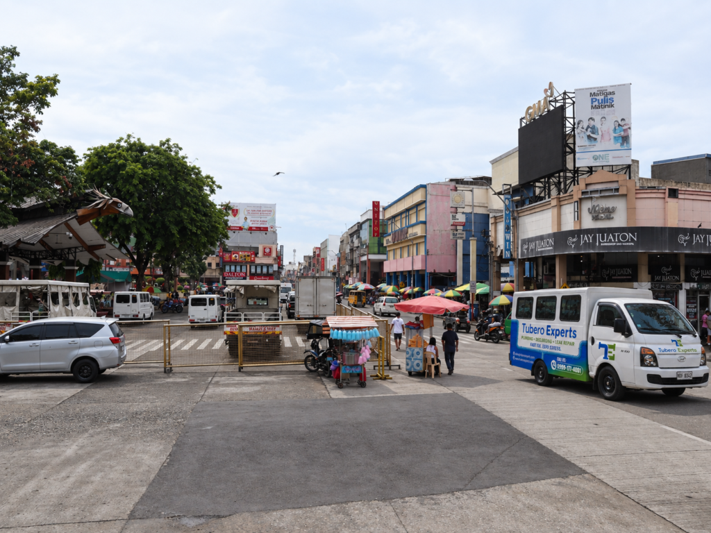 Tubero Experts service van parked along a busy downtown street