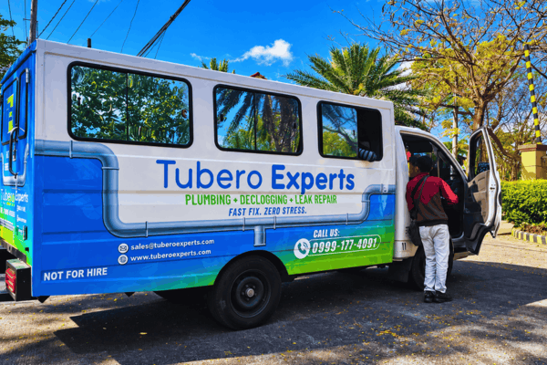 Tubero Experts van parked on a sunny street with its side door open